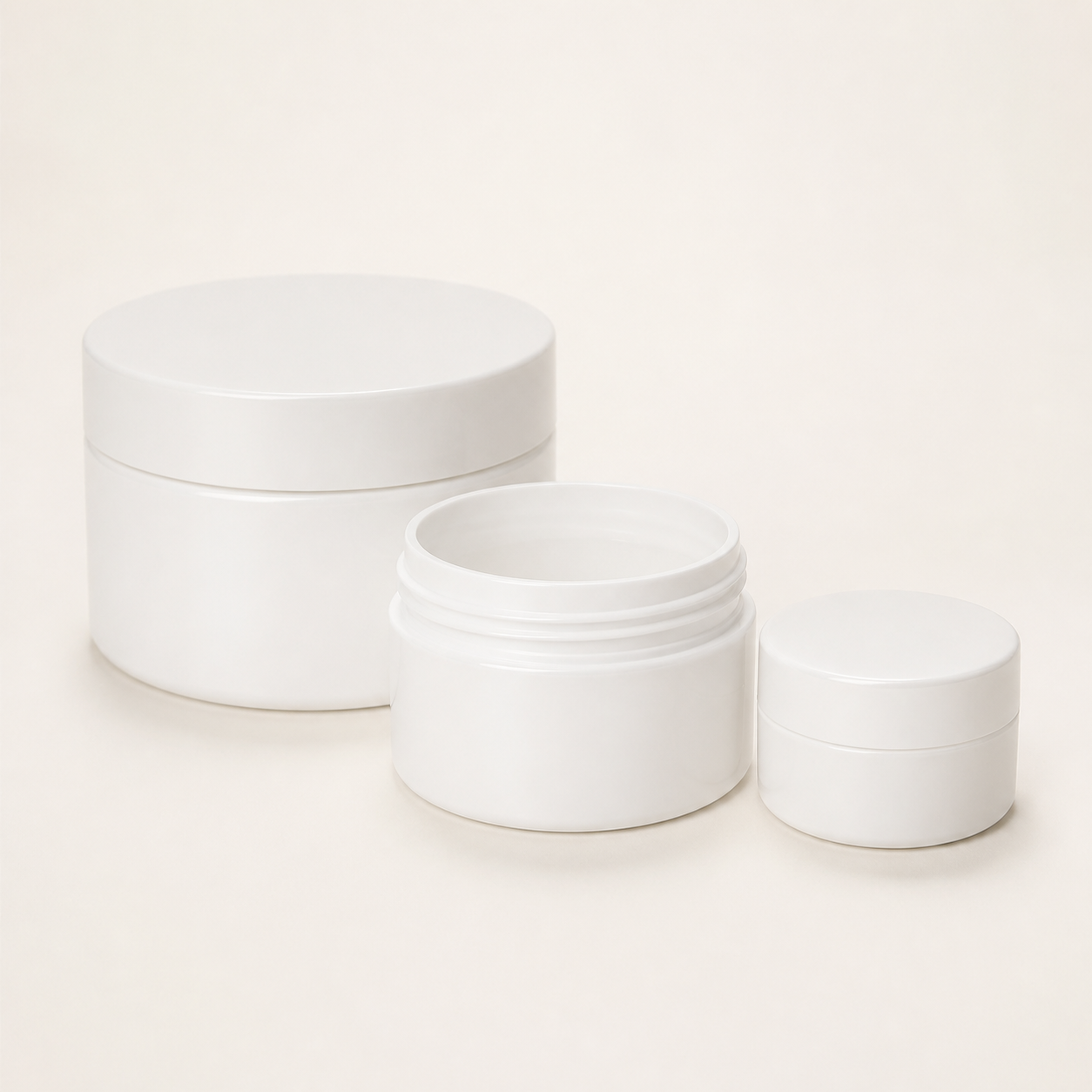 Empty white polypropylene aqueous cream jars in assorted sizes