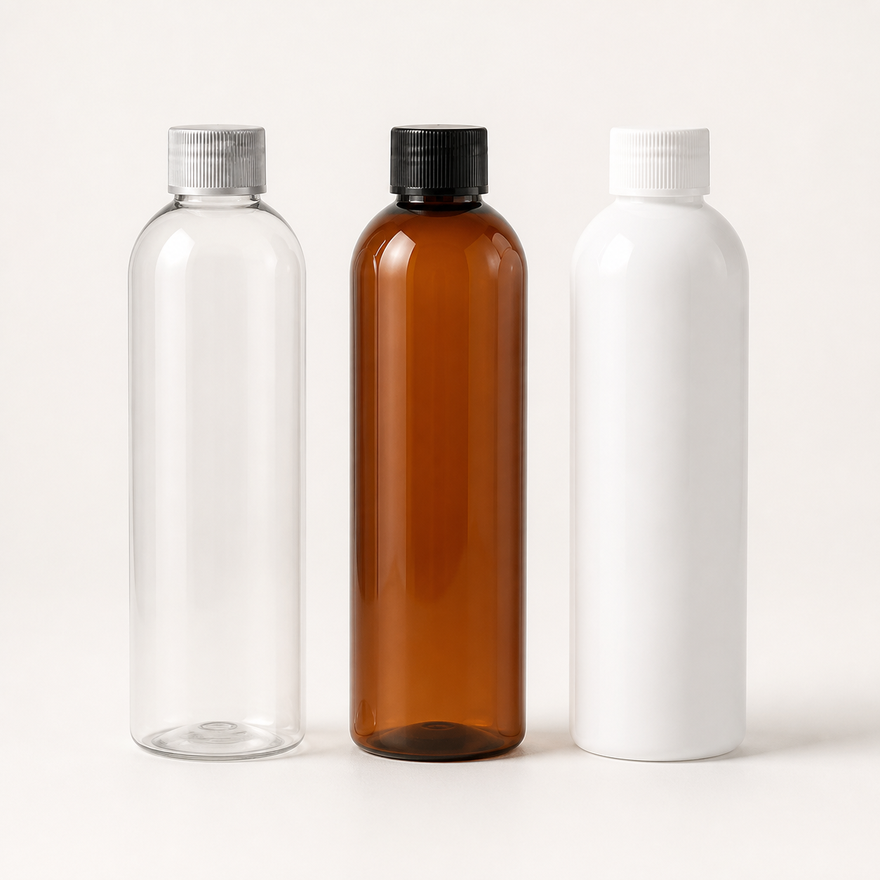 Slim bullet-shaped clear amber and white cosmetic bottles