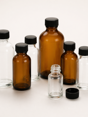 Empty clear and amber round glass bottles with screw caps