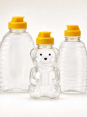 Empty clear PET honey squeeze bottles with yellow dispensing caps