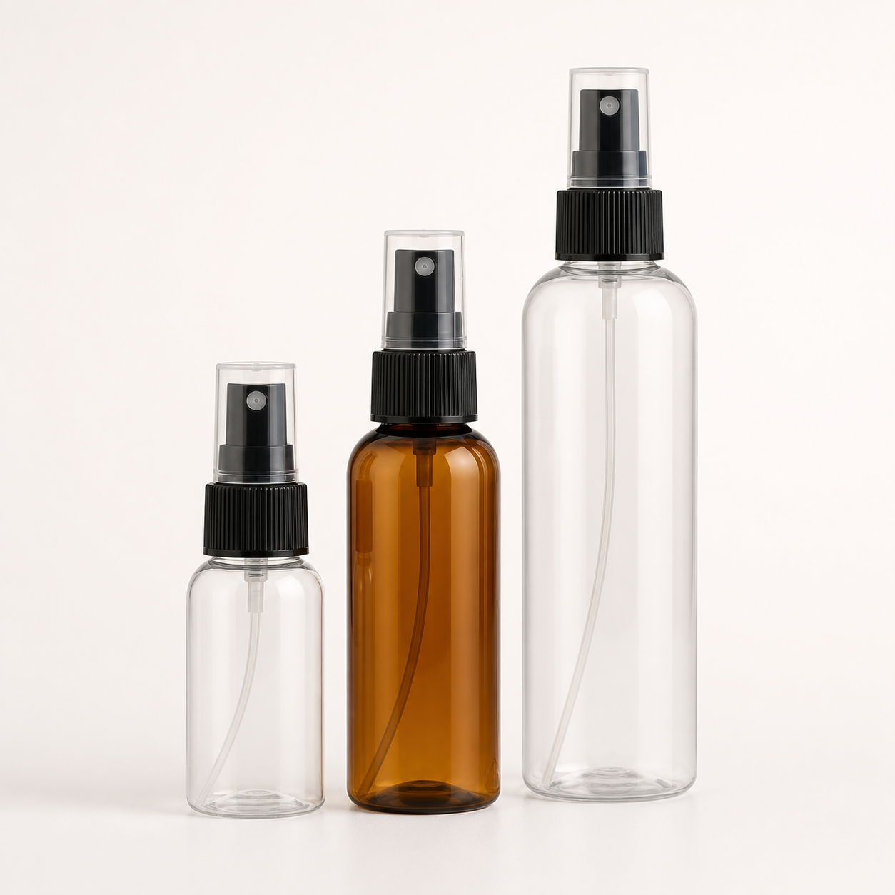 Clear and amber PET fine-mist spray bottles with overcaps