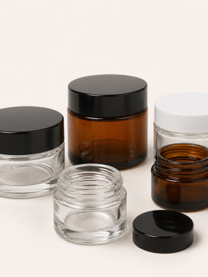Clear and amber cosmetic glass jars with screw lids
