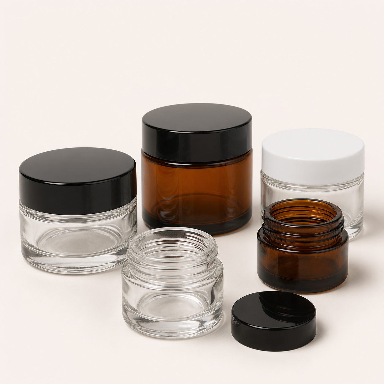 Clear and amber cosmetic glass jars with screw lids