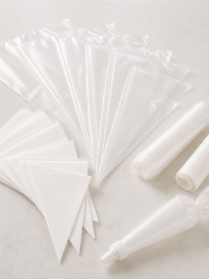Clear and white disposable pastry piping bags in assorted sizes