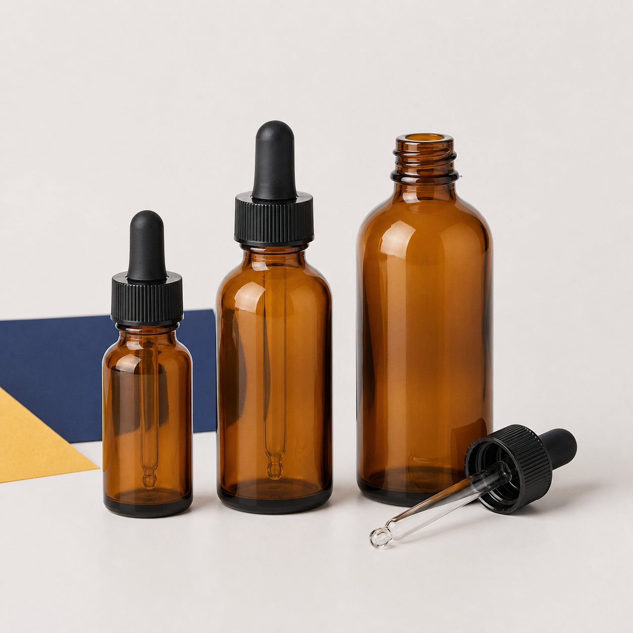 Empty amber glass dropper bottles in assorted sizes