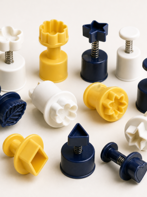 Spring-loaded fondant plunger cutters in assorted decorating shapes