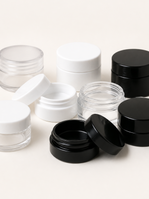 Miniature clear black and white lip balm jars