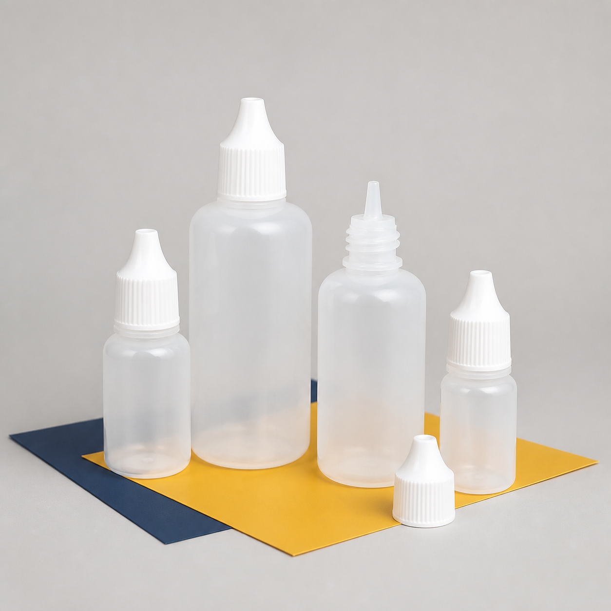 Empty natural translucent plastic squeeze dropper bottles in assorted sizes
