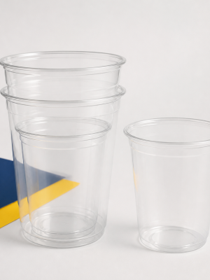 Empty clear compostable PLA smoothie cups in assorted sizes