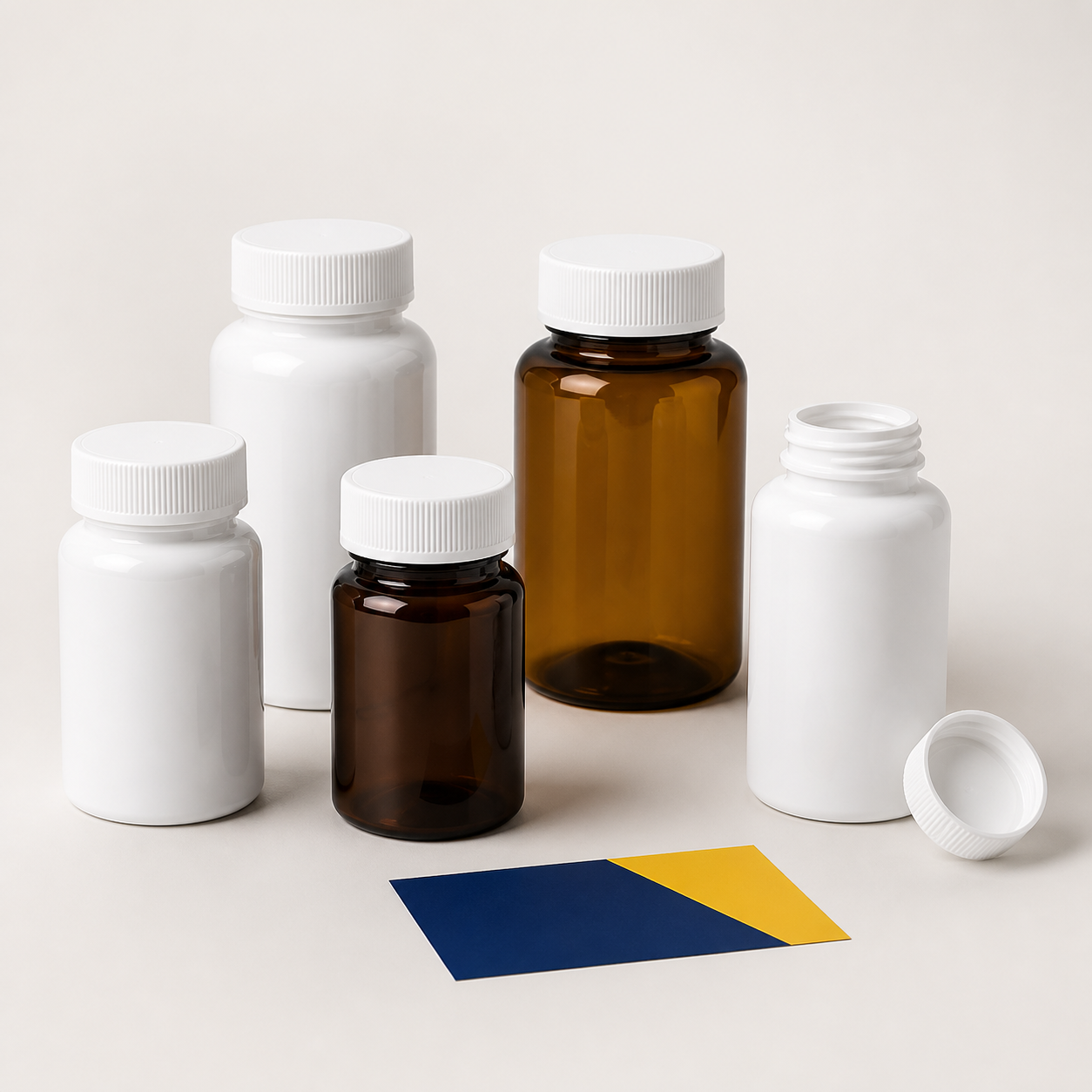 Empty white and amber plastic tablet bottles with screw caps